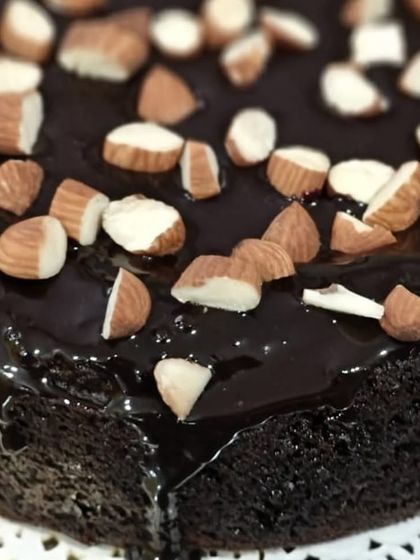 A closer look at the glossy chocolate ganache and toasted almonds on my healthy chocolate cake. It's the ideal guilt-free treat for your next celebration.