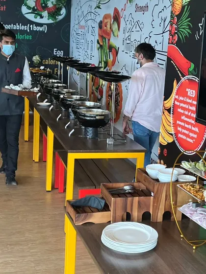 Guests at the corporate event enjoying the buffet. The setup is designed for a smooth and efficient service flow, which is crucial for business lunches.