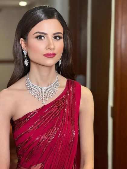 A stunning reception look in a Gaurav Gupta saree. The makeup is clean and glamorous, with a bold red lip that adds a touch of classic Hollywood elegance.