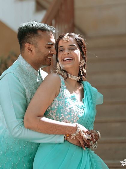A candid portrait of the couple laughing together, showcasing the genuine joy of their pre-wedding celebrations.