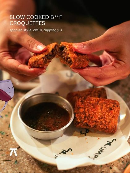 Slow-cooked beef croquettes with a Spanish-style chili dipping jus, a hearty and flavorful small plate from the Grumps, Goa event.