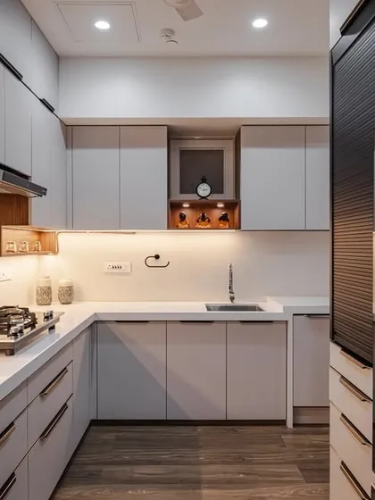 This view highlights the smart layout of the C-shaped kitchen, with a tall unit featuring a rolling shutter for appliances. Every element is placed for maximum efficiency and aesthetic appeal.