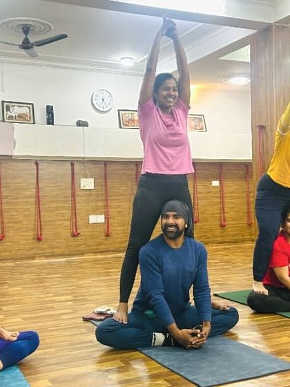 Our studio is a place for creative expression and teamwork. This fun group pose shows how we build pyramids of strength and smiles in our partner yoga classes.