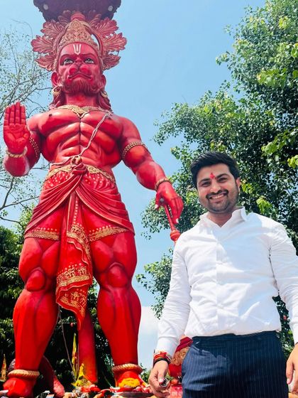 Standing before a statue of Lord Hanuman. His strength and devotion are an inspiration in my fight for justice.