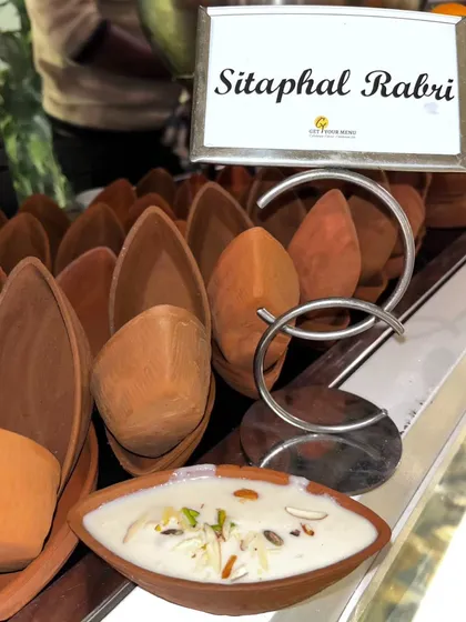 Creamy Sitaphal (Custard Apple) Rabri served in traditional clay kullads. A seasonal delicacy that combines thick, sweet rabri with fresh fruit.
