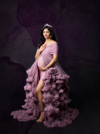 A moody and artistic portrait in a lavender gown. The dark, smoky background and elegant tiara create a feeling of mystery and enchantment.
