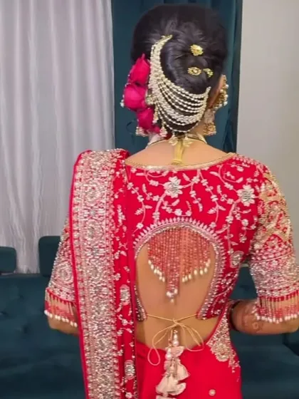 The back view is just as important. Here you can see the detailed bridal bun with a beautiful *passa* and how the dupatta is perfectly draped over the head.