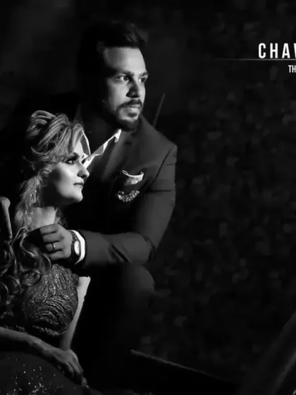 A dramatic black and white couple portrait. The strong lighting and shadows create a cinematic, high-fashion look that is both timeless and modern.