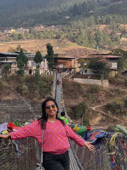 Crossing a suspension bridge adorned with prayer flags in Bhutan. This journey was a reminder of the connection between nature, spirituality, and the creative spirit.