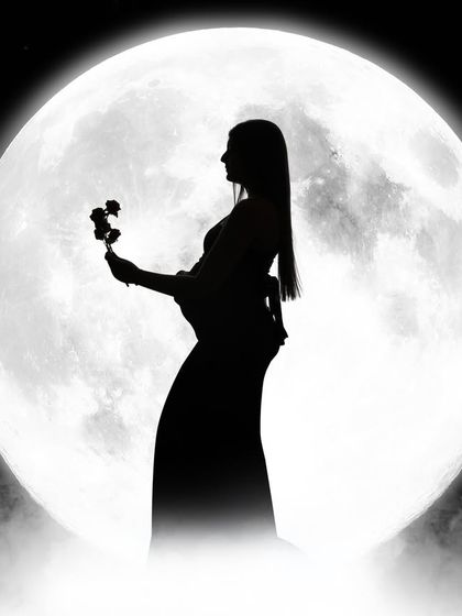 Bumping with love and moonlit dreams. A solo silhouette of a mom-to-be holding a flower against the full moon, creating a poetic and serene image.