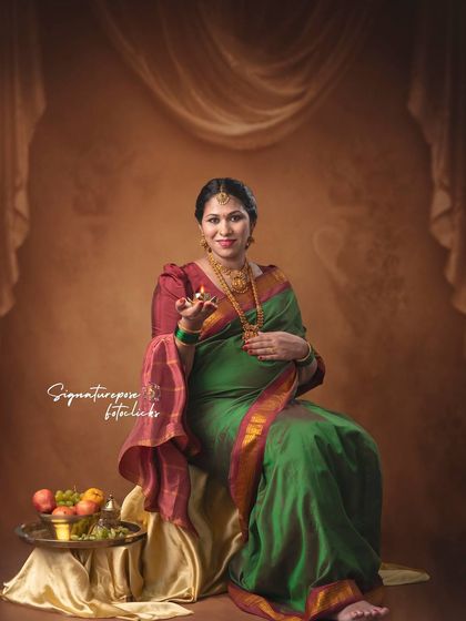 This seated portrait in a green saree has a classic, timeless quality, perfect for a fine art print.