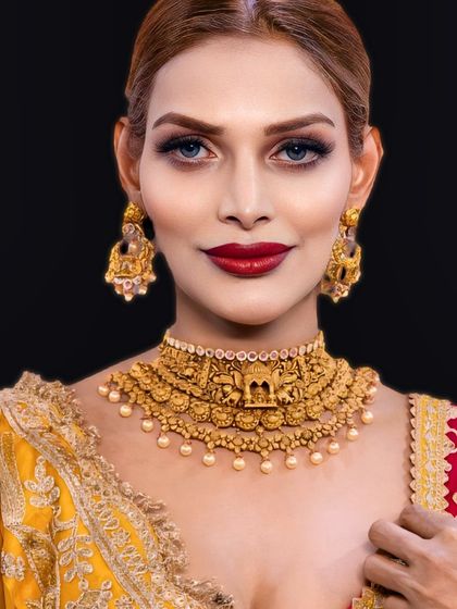 A classic look featuring a timeless red lip. Paired with soft, smokey eyes and traditional gold jewelry, this style is the epitome of grace and elegance.