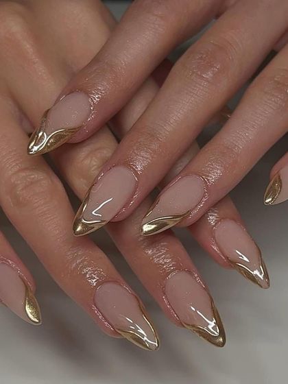For the minimalist bride who loves a touch of gold. These long, almond-shaped nails feature a simple but stunning liquid gold chrome tip.