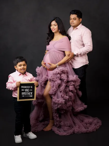 Welcoming a new baby is a family affair. This maternity portrait shows how we include the whole family, especially the proud big brother-to-be, in celebrating the journey and anticipation of a new arrival.