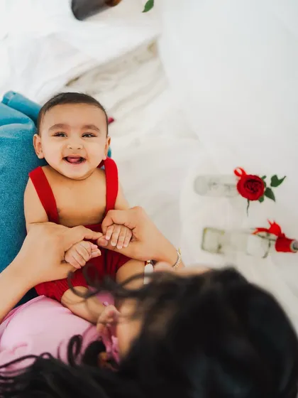 A happy baby enjoying some playtime with mom. His smile is absolutely infectious.
