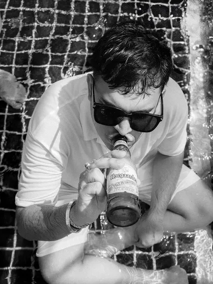 A candid black and white shot of a guest relaxing in the pool, capturing the casual and fun atmosphere.