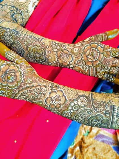 A look at the fresh henna paste for two different bridal designs, showing the precision of the application.