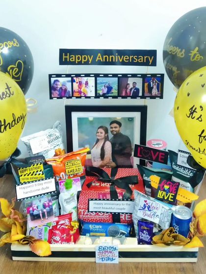When a birthday and anniversary fall together, it calls for a double celebration. This hamper combines elements for both occasions, with festive balloons, a framed photo, and plenty of snacks.