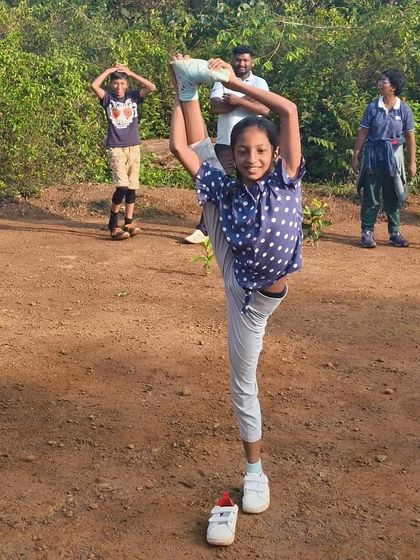 A participant shows incredible flexibility during a morning stretching session, proving that adventure and wellness go hand in hand.