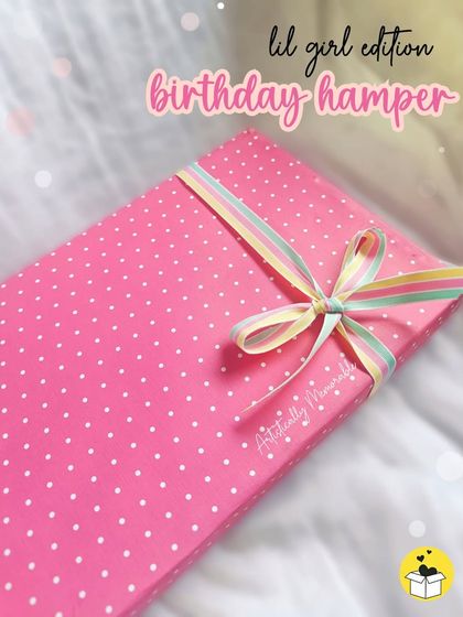 The "lil girl edition" birthday hamper, all wrapped up in a cute pink polka dot box with a rainbow ribbon. The surprise starts from the outside.