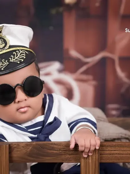 Captain of the ship, and of our hearts. A close-up of our little sailor, looking cool and confident. We use costumes and props to make every milestone shoot a fun adventure.