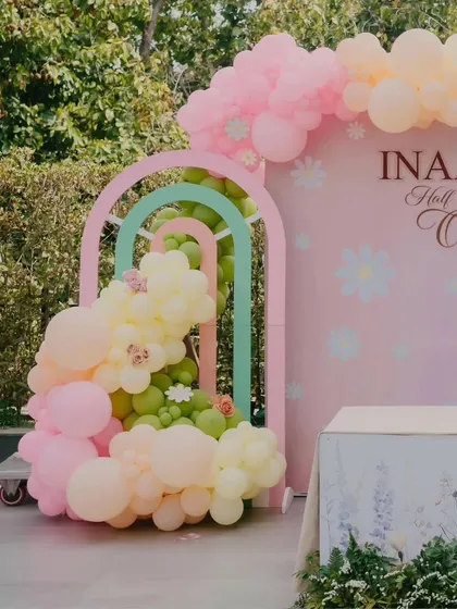 A closer look at the nested rainbow arches and the cascading pastel balloon arrangement from Inaaya's party.