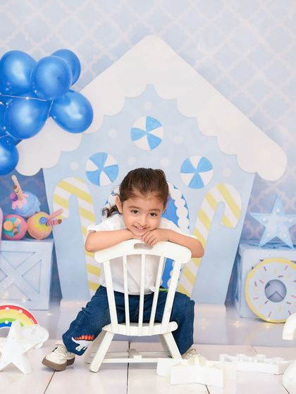A sweet and relaxed pose in a candy-themed setup. The pastel colors and fun props create a whimsical and delightful atmosphere.