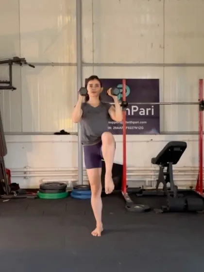 A standing march with a dumbbell hold. This move is part of our standing Pilates series, focusing on core stability and lower body control.