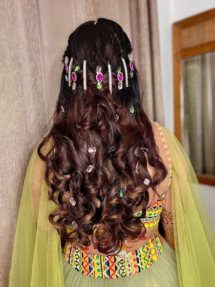 Let's bling it. For Surbhi's mehndi, we used a color-curated Swarovski scheme to create this dazzling hairstyle.