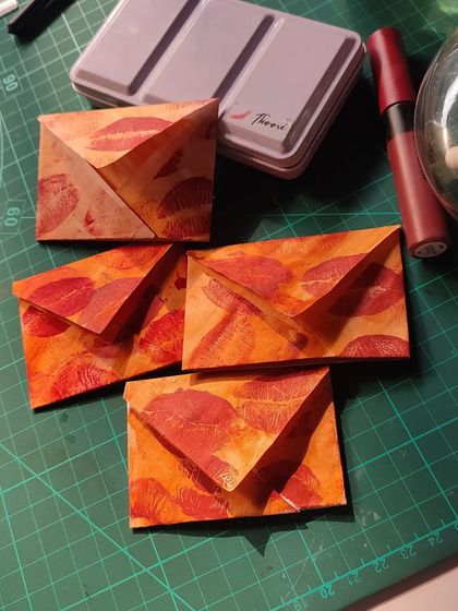 A collection of my vintage-style mini envelopes, all stained with coffee and stamped with lipstick kisses.