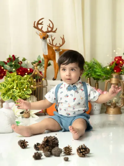 Exploring the festive props. Before the cake smash, I let babies get comfortable with the set, which leads to natural and adorable photos like this one.