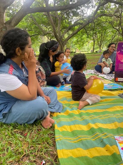 Parents and children sitting together, enjoying the story. We create a space where families can connect with each other and with new friends.
