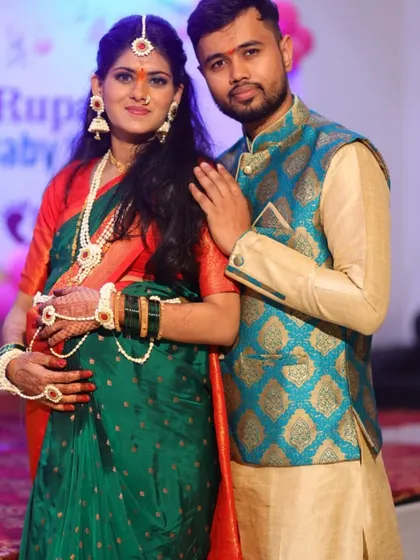 A sweet portrait of the expecting couple. Her jewellery set includes a maang tikka, necklace, earrings, and hathphool.