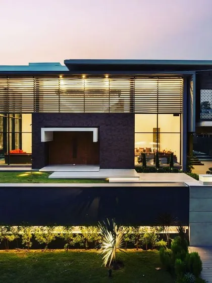 Here, I applied a grazing light technique to the exterior of Mr. Lally's residence. This method casts light across the surface at a sharp angle, revealing the subtle textures of the brickwork and creating dramatic shadows.