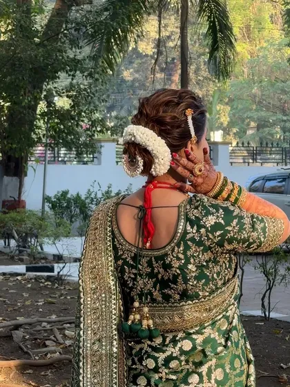 Another angle of the beautiful bridal hairstyle, showcasing the floral gajra.