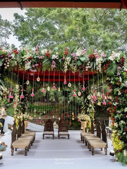 Imagine exchanging your vows here. Our spaces are a living canvas, ready to be transformed into your vision. This stunning floral mandap, set against our natural greenery, shows how beautifully tradition and nature can intertwine.