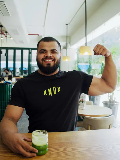 Coach Vinay enjoying a post-workout green juice at our in-house cafe. We believe in a holistic approach to health that includes nutrition and recovery.