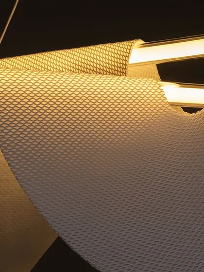 A macro shot of the Drape Light's textured, fabric-like material, which is specially designed to be rigid yet appear soft and flowing.