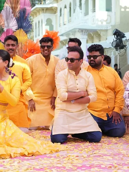 Another fun pose from the boys on stage. The colorful backdrop and happy faces make for a perfect Haldi picture.