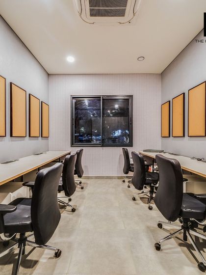 This is the open-plan workspace within the Embassy marketing office, featuring rows of desks and acoustic panels. The design prioritizes a clean, organized, and productive environment for the sales team.