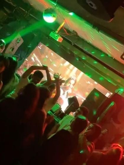 The view from the DJ booth at Social Koramangala during a packed Friday night. The green laser lights add to the electrifying atmosphere.