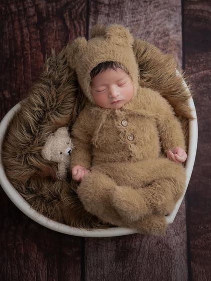 Our classiest newborn shoots, with all the focus on your adorable little one. This heart-shaped bowl and teddy bear outfit create a portrait that is full of warmth and love.