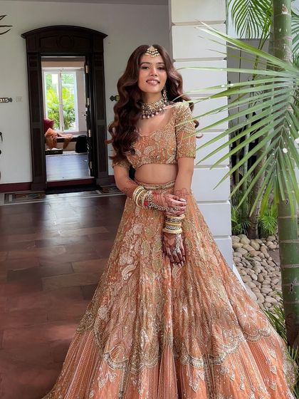 A full length shot of a bride on her wedding day. She chose beautiful, voluminous open waves, a modern choice for a daytime ceremony.