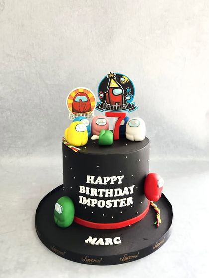 Another fun "Among Us" cake, this time for Marc the "Imposter." The black cake with a starry pattern makes the colourful characters pop.