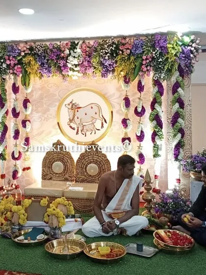 A pooja ceremony in progress, set against our beautiful backdrop with a sacred cow motif. This image shows how our decorations create the perfect environment for performing traditional rituals.