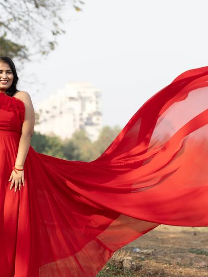 This one-shoulder red ruffle gown is another fantastic option for a pre-wedding shoot. The long, flowing tail catches the wind beautifully for those perfect candid shots.