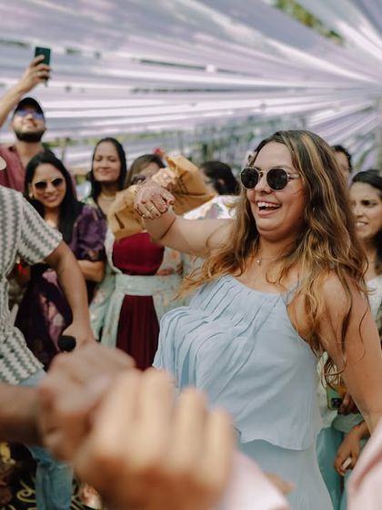 Guests dancing with abandon at a pool party. We capture the energy of the entire wedding party, not just the couple.