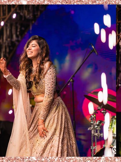 The bride enjoying her sangeet performance, looking absolutely radiant and happy.