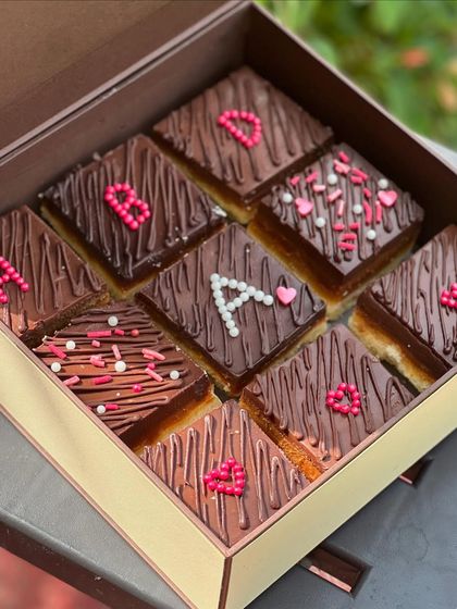 I love creating personalized treats. These custom chocolate bars were decorated with initials and hearts, making them a unique and sweet gift for a special client.