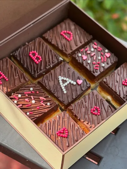 I love creating personalized treats. These custom chocolate bars were decorated with initials and hearts, making them a unique and sweet gift for a special client.